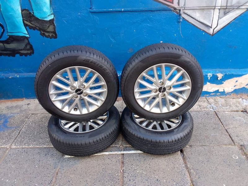 Set of 15inches original k i a rio mags rim 4x100 p c d with 90% thread tyres both rims and tyres