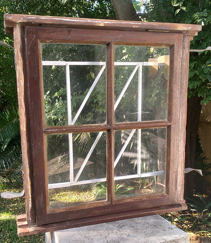Wooden window with glass panels and built-in burglar bars