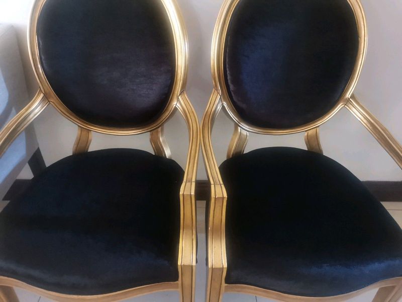 Two French antique arm chairs in black and gold