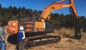 Hitachi excavator with log grapple