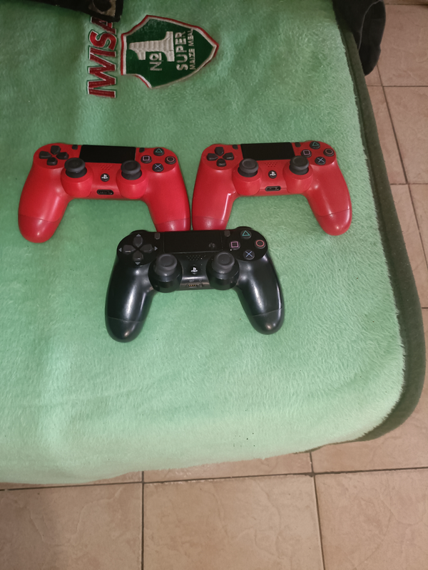 If three ps controlers two red one black very good as new 076678845
