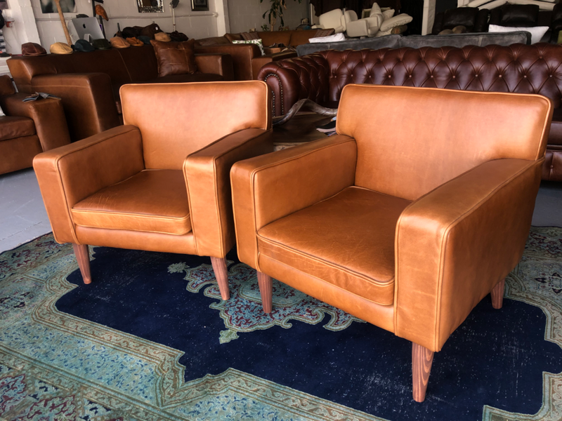 Brand new gameskin genuine leather  MID-CENTURY armchairs. (A modern streamline design) R6500 each .