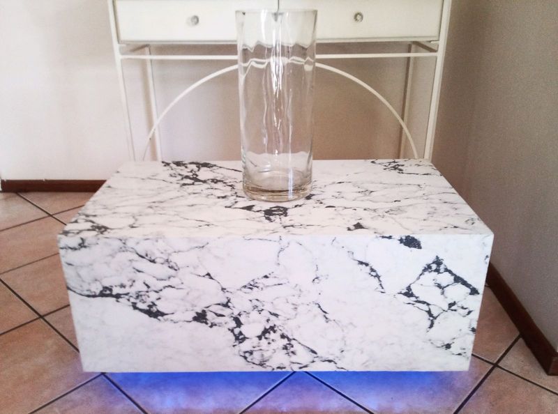 Stone coffee table floating on light