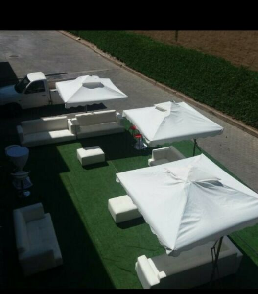 White garden umbrellas hire, Outdoor white couches and cocktail set up.