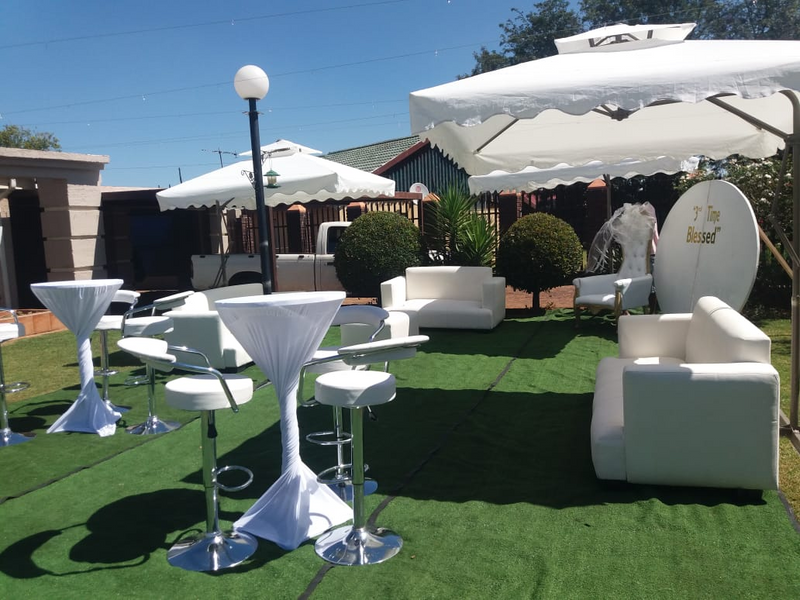 ALL WHITE OUTDOOR DECOR SET UP. GARDEN UMBRELLAS AND WHITE VIP COUCHES SET UP. COCKTAIL SET UP
