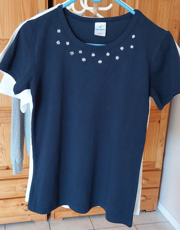 Hand embroidered white flowers on a navy t-shirt