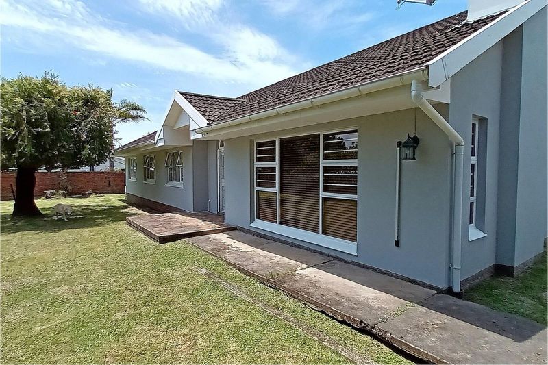 Welcome to this charming family home nestled on a spacious 1412 sq.m level erf .
