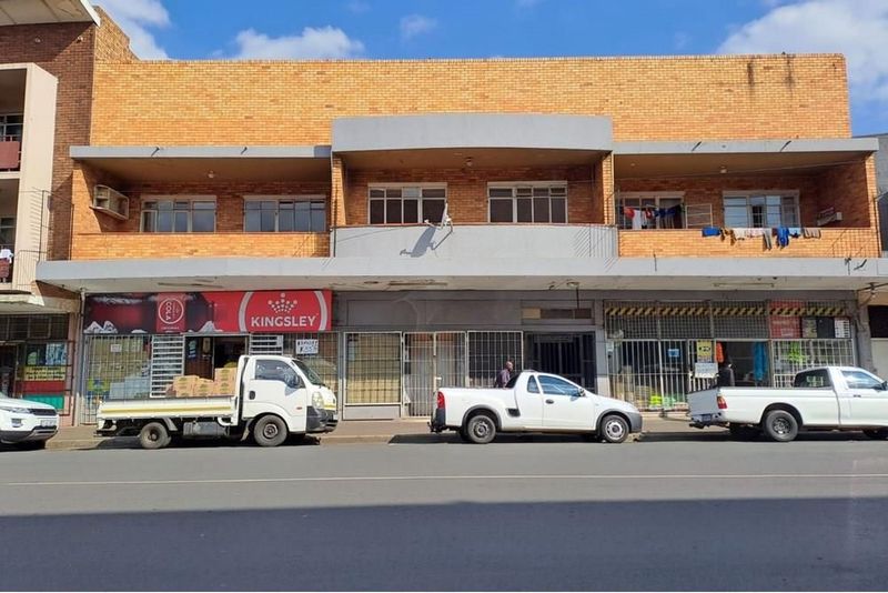 This commercial building boasts a prime location on a bustling main road.
