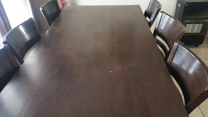 Dark wood dining room table with 6 chairs