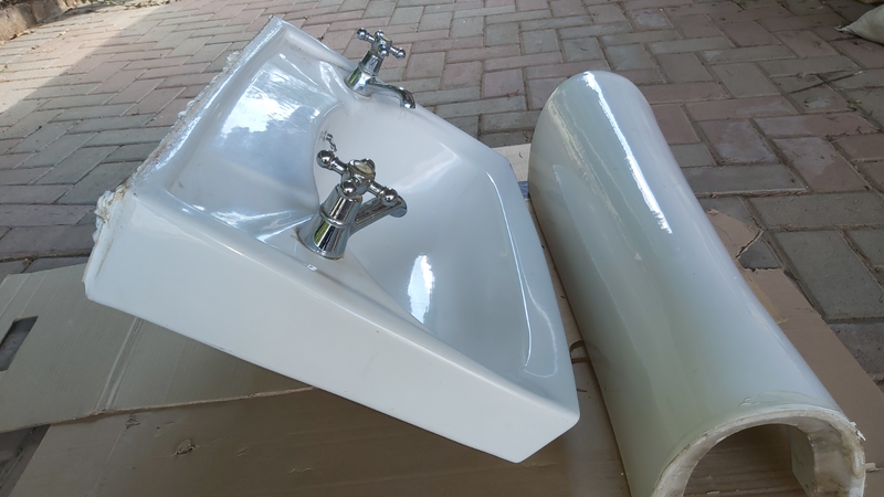 White used hand basin with 2 taps and outlet plug