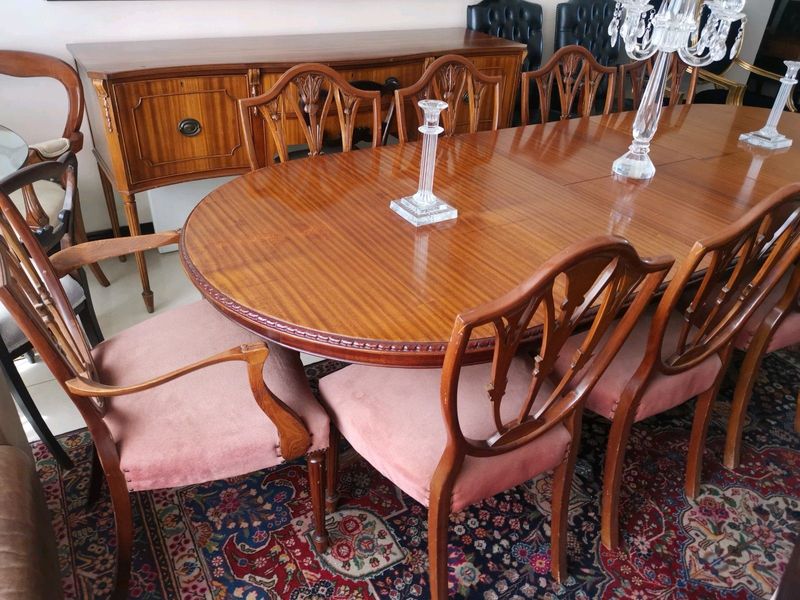 An elegant antique 10 seater dinning suite with a server in exceptional condition.