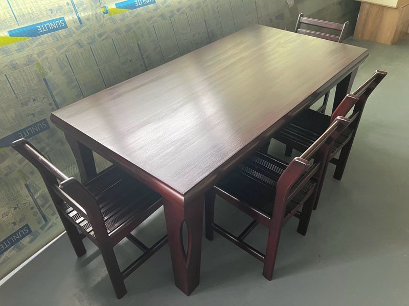 Six seater Mahogany dinning room table with glass counter and chairs