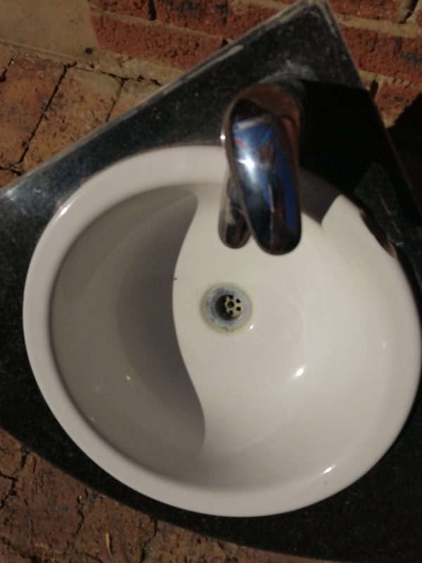 Basin with tap on granite top