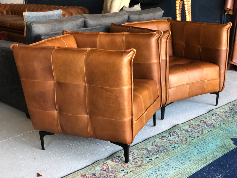 2 x Brand new CONTEMPORARY DESIGN genuine leather armchairs. (TUFFED STITCH DETAILING) R9995 each.