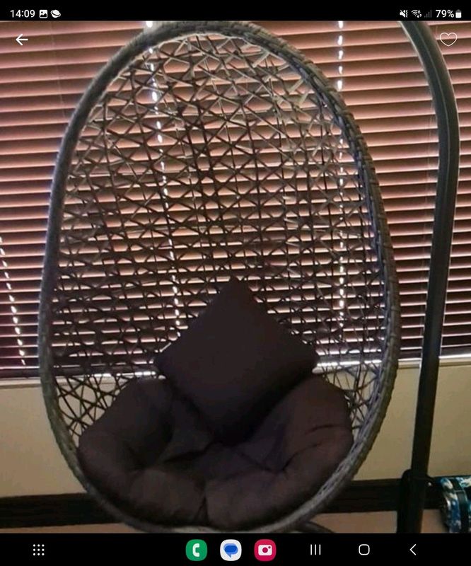 Swing chair includes black cushions