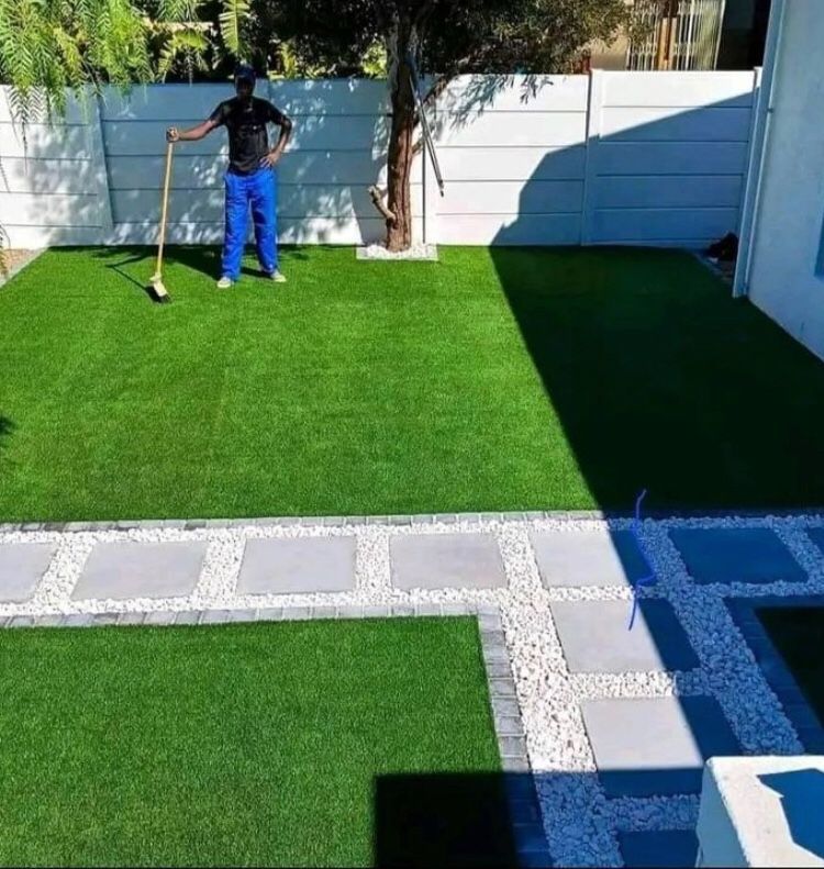 Artificial synthetic grass and brown decorative stones