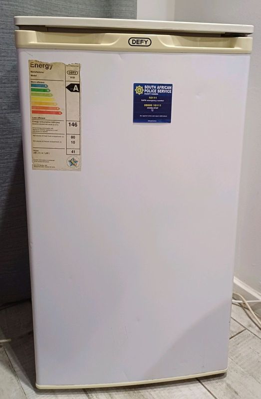 A Defy white bar fridge is for sale in Sandton, 0848 120008.