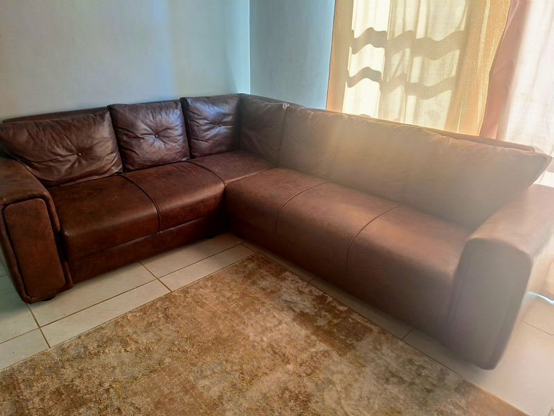 L shaped leather and swade couch