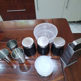 coffee canister, enamel cups, grater and Tupperware&#39;s without lids.