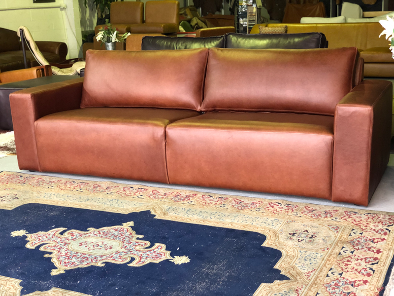Immaculate 2.4m genuine leather MARCONI three seater couch. (LARGE TWO DIVISION SEATING PLATFORM)