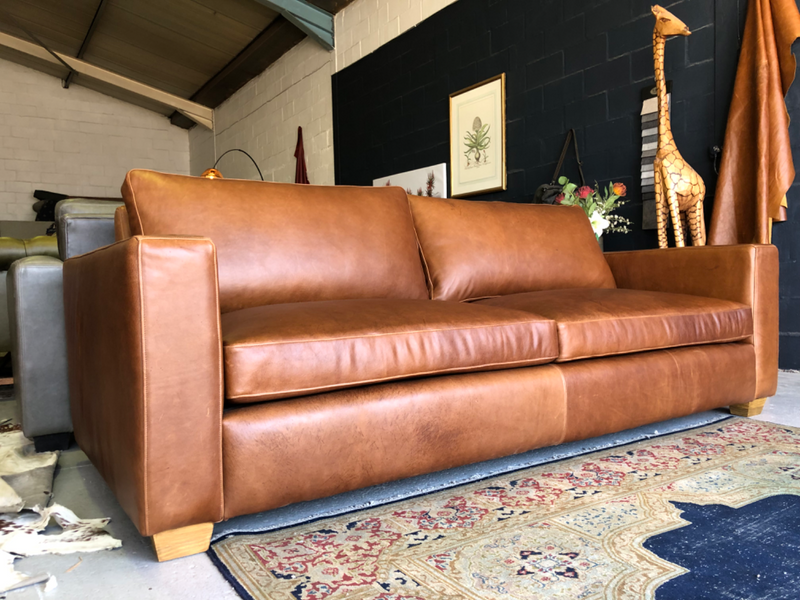 Brand new 2.2m full grain gameskin genuine leather MODERN STREAMLINE DESIGN three seater sofa.