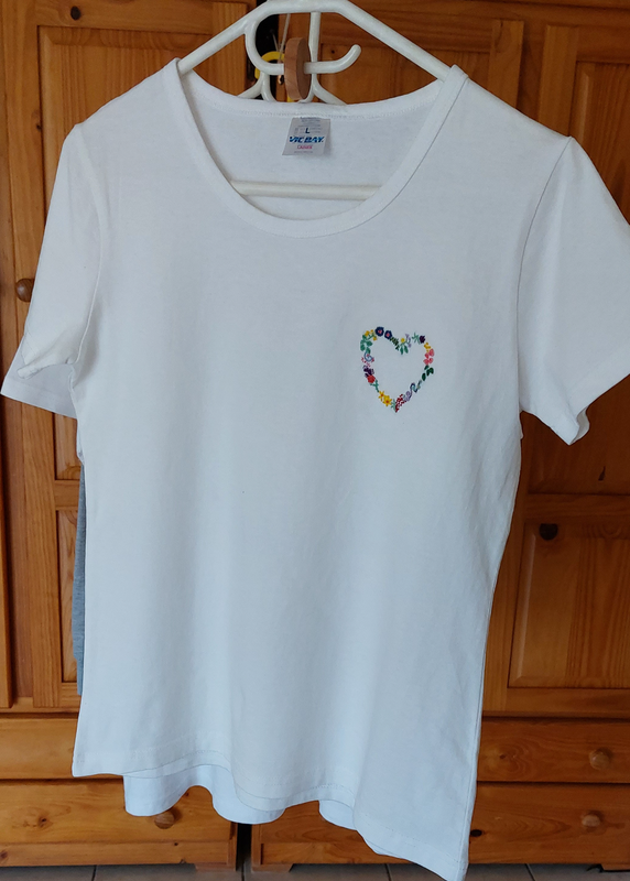 Hand embroidered floral heart on a white t-shirt