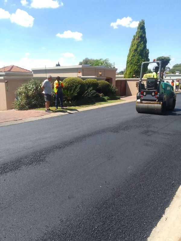 Tar surfacing and brick paving