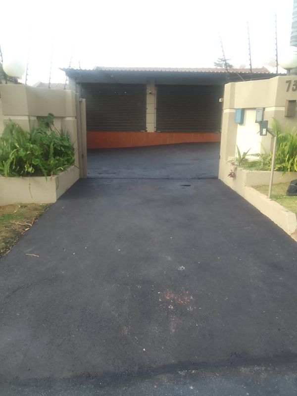 Tar surfacing and brick paving