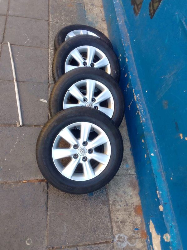 A set of 15inches original toyota corolla quest mags 5x114.3 PCD with tyres