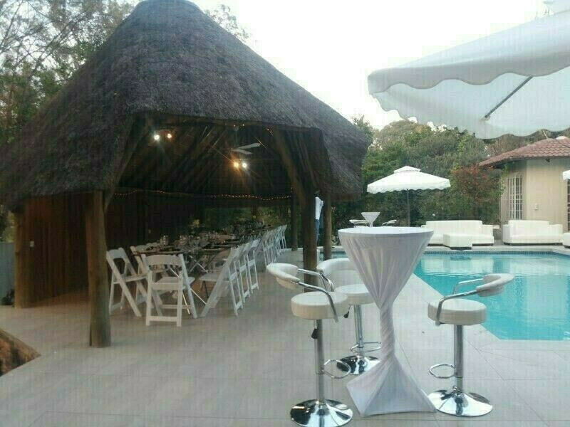 Garden umbrellas and outdoor white couches set up. Please book or your event.