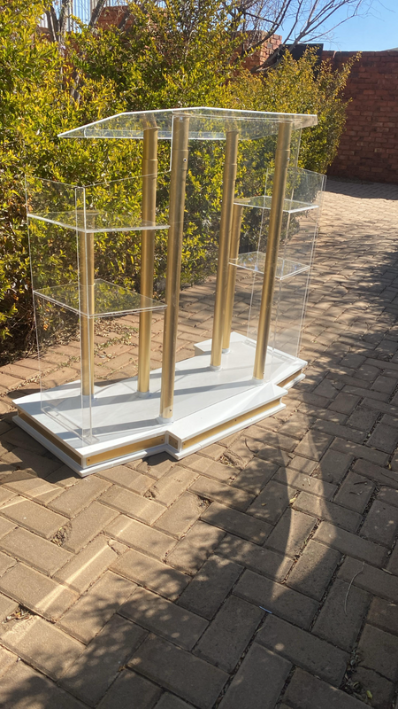 CUSTOM DESIGNED WINGSTYLE PULPIT WITH GOLDEN POLES AND A WHITE BASE