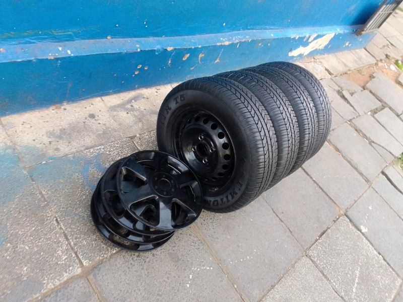 A set of 13inches original datsun go steel rims 4x100 PCD wheel covers and tyres tyres are 97%