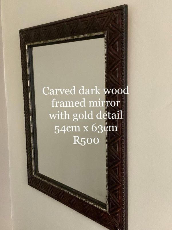 Carved dark wood framed mirror