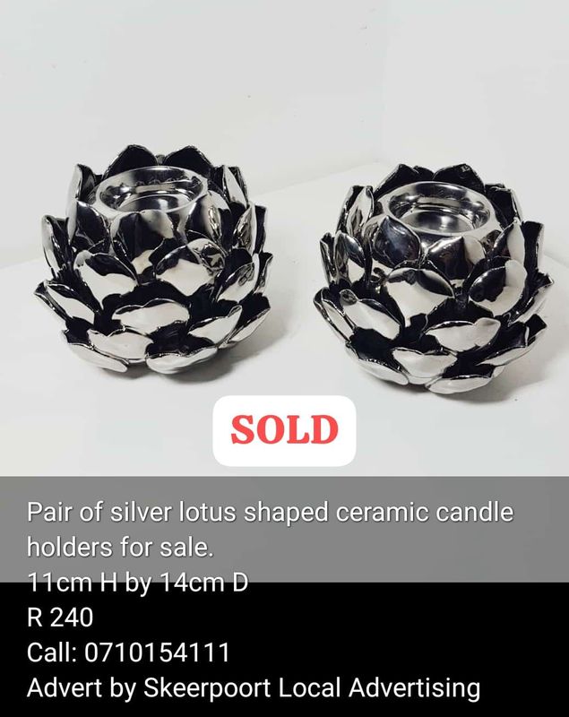 Pair of lutus shaped ceramic candle holders for sale.