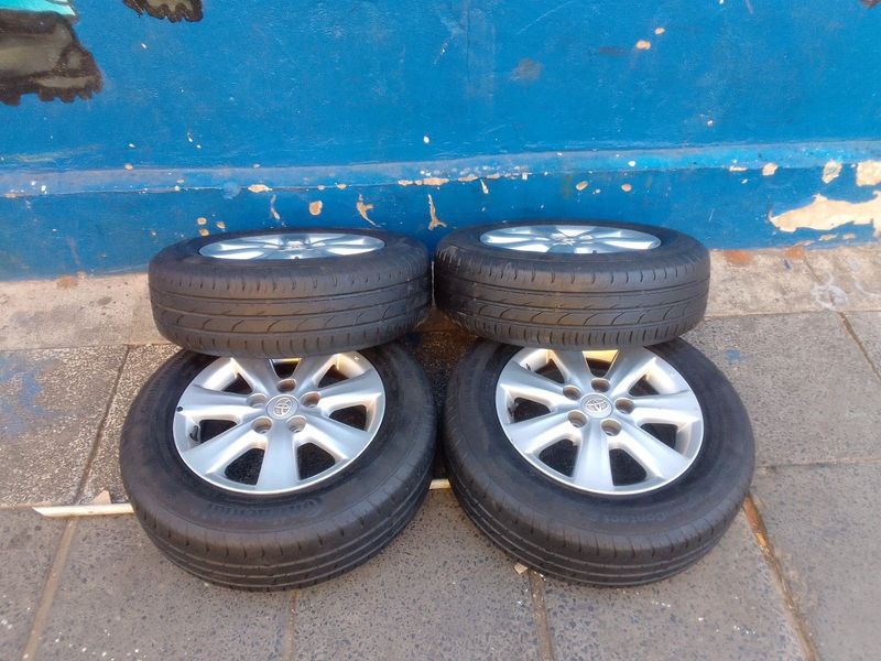 A set of 15inches original Toyota corolla quest mags 5x114.3 PCD with Tyres