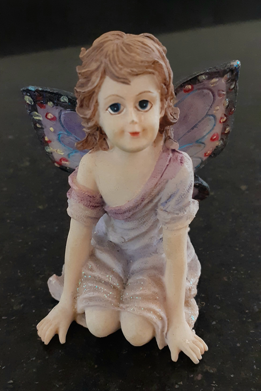 Resin fairy figurine with glitter.