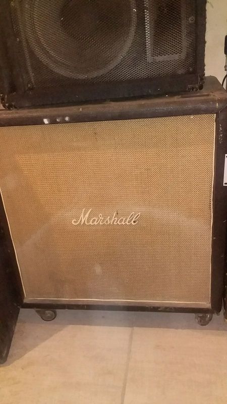 Vintage Marshall bass amp and cab with 4 speakers.