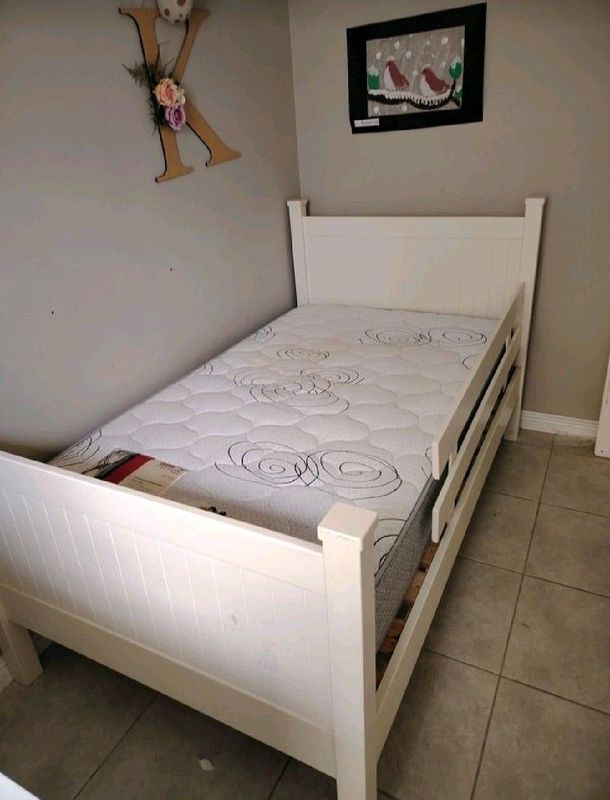 Pre-loved White solid wooden toddler bed in excellent condition