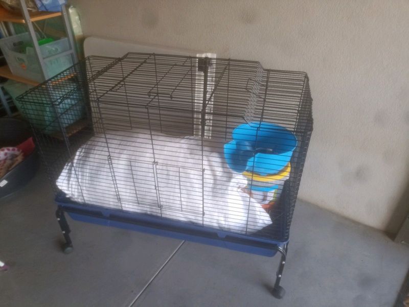 Rabbit cage with trolley, food, food bowl, water dispenser,hay and small shelter