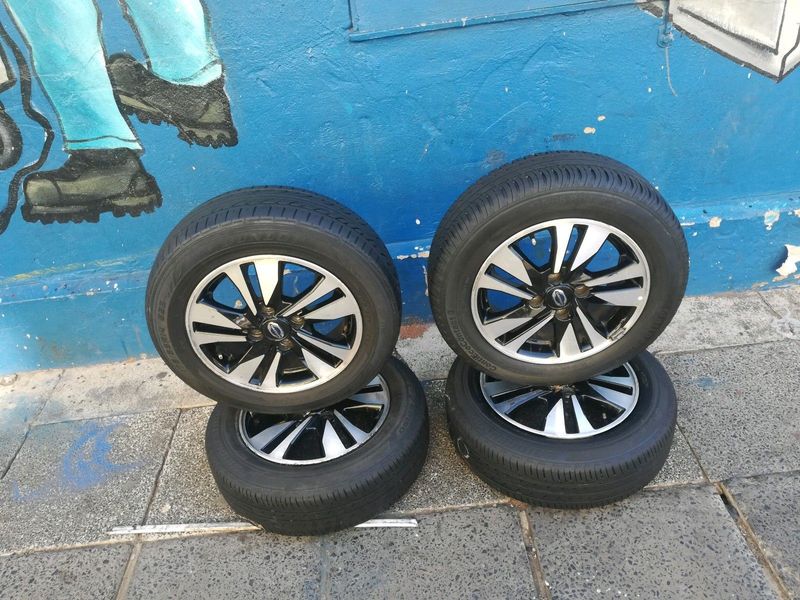 A set of 14inches original Datsun go mags rim 4x100 PCD with tyres