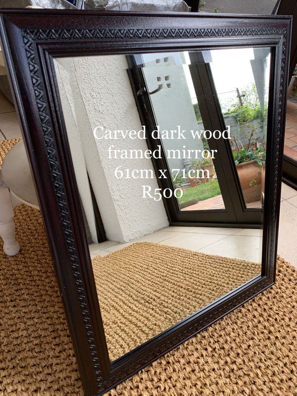 Carved dark wood framed mirror