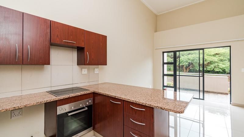 Newly tiled 1 bed 1 bath unit on the first floor with double volume ceilings
