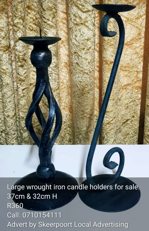Large wrought iron candle holders for sale.