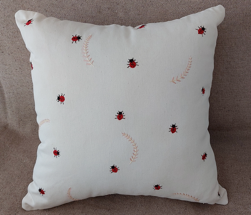 Hand embroidered ladybug and leaf cushion