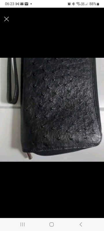 Genuine black ostrich leather, passport, travel wallet.