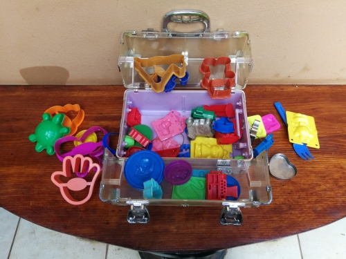 Collection of kids plastic dough cutters and moulds.