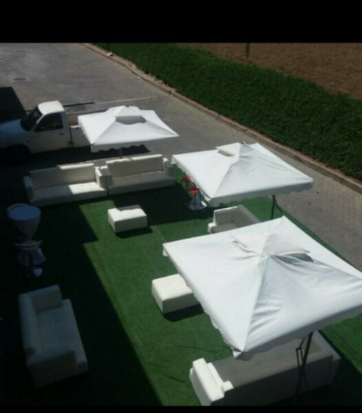 Umbrellas and white couches hire. Cocktail set up, bar tables and bar stools hire.