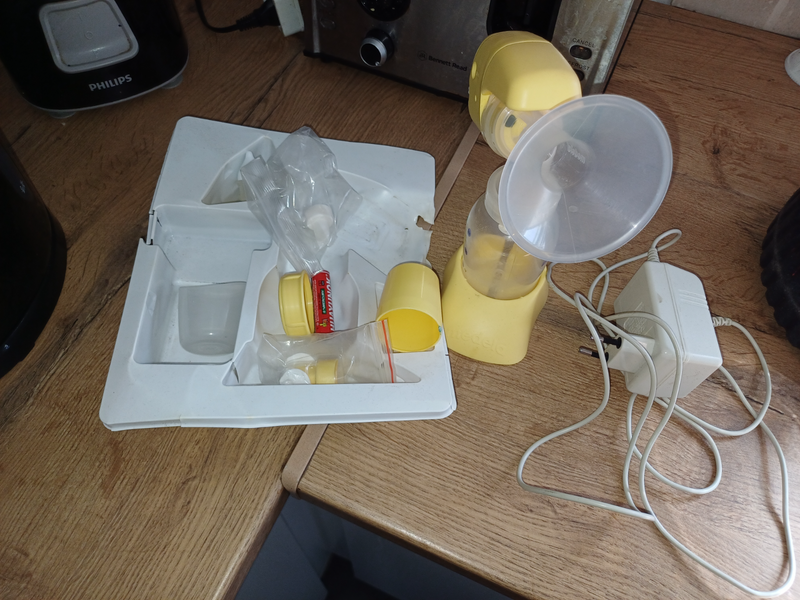 Medela. Ini electric breast pump and bag of bottles and breast pump storing bags