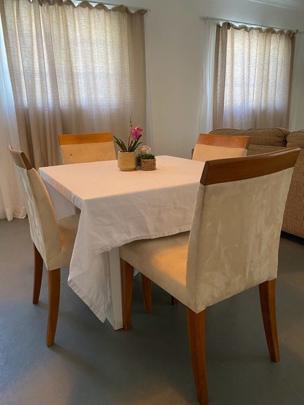 Dinner table with chairs and table clothe