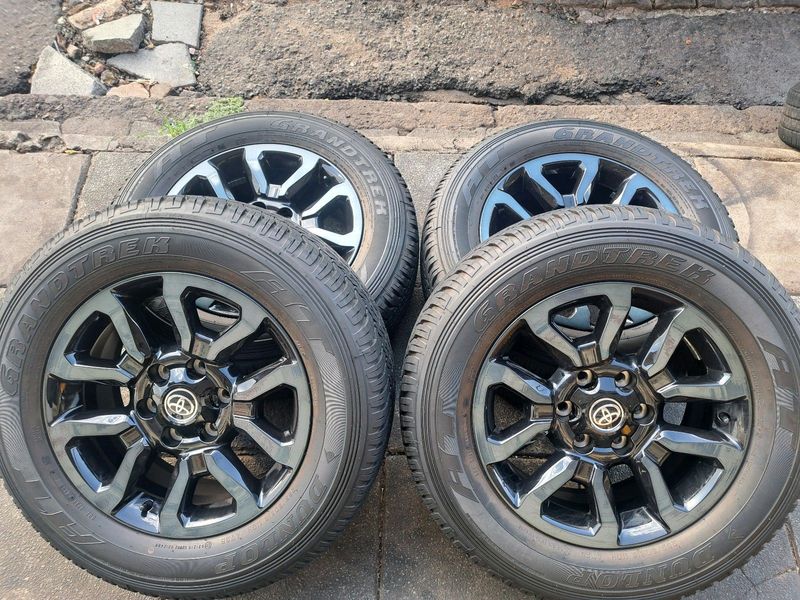 18 Inch Toyota Hilux legend 50, Fortuner mags with 98% Dunlop Grandtrek tires for sale.